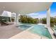 Luxury pool and spa with waterfront views in a modern backyard at 7003 Holmes Blvd, Holmes Beach, FL 34217