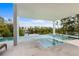 Modern pool and spa offering beautiful waterfront views in a tropical backyard at 7003 Holmes Blvd, Holmes Beach, FL 34217