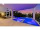 Stunning pool and spa area with ambient lighting, offering a luxurious waterfront living experience at 7003 Holmes Blvd, Holmes Beach, FL 34217