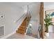 An indoor wood staircase with glass railing and a modern wood slat wall at 7003 Holmes Blvd, Holmes Beach, FL 34217