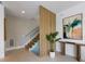 Modern staircase design with glass railings, wood steps, and a decorative wood slat wall at 7003 Holmes Blvd, Holmes Beach, FL 34217