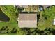 Aerial view of the home showcases the roof, lush landscaping, and proximity to a pond at 7407 29Th Avenue W Dr # 2288, Bradenton, FL 34209