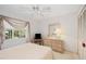 Bright bedroom features neutral carpet, updated ceiling fan, and window with airy decorative curtains at 7407 29Th Avenue W Dr # 2288, Bradenton, FL 34209