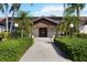 Exterior view of the clubhouse; a sidewalk is flanked by lush landscaping at 7407 29Th Avenue W Dr # 2288, Bradenton, FL 34209