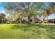 Exterior of a two-story condo building boasts mature landscaping, a large shade tree, and stairway access at 7407 29Th Avenue W Dr # 2288, Bradenton, FL 34209