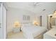 Bright bedroom featuring neutral colors, a ceiling fan, and an ensuite bathroom at 7407 29Th Avenue W Dr # 2288, Bradenton, FL 34209