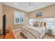 Bedroom with natural light, neutral decor, and wood-look floors at 7665 Portstewart Dr, Lakewood Ranch, FL 34202