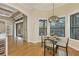 Breakfast nook featuring a modern chandelier, large windows, and hardwood floors at 7665 Portstewart Dr, Lakewood Ranch, FL 34202
