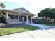 Community clubhouse featuring covered entrance and outdoor seating area at 7665 Portstewart Dr, Lakewood Ranch, FL 34202