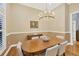 Formal dining room featuring hardwood floors and an elegant chandelier at 7665 Portstewart Dr, Lakewood Ranch, FL 34202