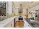 Gourmet kitchen with stainless steel appliances, white cabinetry, mosaic tile backsplash and hardwood floors at 7665 Portstewart Dr, Lakewood Ranch, FL 34202