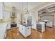 Gourmet kitchen with stainless steel appliances, an island with dark countertop, and a built-in wine refrigerator at 7665 Portstewart Dr, Lakewood Ranch, FL 34202