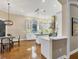 Open concept kitchen featuring white cabinets, stainless appliances, hardwood floors and decorative backsplash at 7665 Portstewart Dr, Lakewood Ranch, FL 34202
