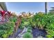 Lush landscaping features a stone walkway, vibrant plants and shrubs, creating a serene outdoor space at 7665 Portstewart Dr, Lakewood Ranch, FL 34202