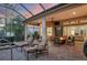 Outdoor living space featuring a brick patio with comfortable seating, a fire pit, and a view of the lush landscaping at 7665 Portstewart Dr, Lakewood Ranch, FL 34202