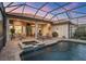 Backyard pool and spa area with brick patio, lounge chairs, and a covered patio for outdoor entertaining at 7665 Portstewart Dr, Lakewood Ranch, FL 34202
