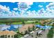 Aerial perspective highlighting condos, lake, and the golf course providing picturesque community setting at 7911 Grand Estuary Trl # 102, Bradenton, FL 34212