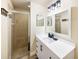 Modern bathroom featuring a glass-enclosed shower and a sleek vanity at 7911 Grand Estuary Trl # 102, Bradenton, FL 34212