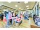 Well-lit retail space displaying clothing, shoes, and golf equipment at 7911 Grand Estuary Trl # 102, Bradenton, FL 34212