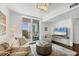 Living room with modern furniture, hardwood floors, and a view of the ocean from the balcony at 800 N Tamiami Trl # 509, Sarasota, FL 34236