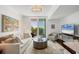 Bright living room with balcony access and modern furnishings creates an inviting and comfortable space at 800 N Tamiami Trl # 509, Sarasota, FL 34236