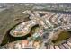 Overhead view of a residential area surrounded by waterways, featuring community amenities at 803 Coral Bean Cv, Venice, FL 34293