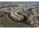 Aerial shot of a waterfront community with winding streets and lush landscaping at 803 Coral Bean Cv, Venice, FL 34293