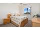 Cozy bedroom featuring a double bed, carpeted floor, and a side table on each side of the bed at 803 Coral Bean Cv, Venice, FL 34293