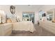Comfortable bedroom with neutral tones, plush carpet, and sliding glass doors leading to an outdoor space at 803 Coral Bean Cv, Venice, FL 34293
