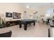 Elegant game room with a pool table, stylish furnishings, and serene ambiance at 803 Coral Bean Cv, Venice, FL 34293
