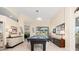 Bright game room with a pool table, neutral walls, tile floors and large windows for natural light at 803 Coral Bean Cv, Venice, FL 34293