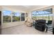 Bright living room featuring tile floors and large windows overlooking a scenic waterfront view at 803 Coral Bean Cv, Venice, FL 34293
