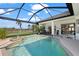 Inviting screened-in pool area with water feature, perfect for outdoor relaxation and entertaining at 803 Coral Bean Cv, Venice, FL 34293