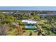 Aerial view of the community pool and shuffleboard areas surrounded by trees at 8140 Terrace Garden N Dr # 103, St Petersburg, FL 33709