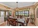 Warm dining room area featuring views to the exterior, neutral paint and wood floors at 8140 Terrace Garden N Dr # 103, St Petersburg, FL 33709