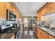 Galley kitchen with stainless appliances, granite counters and tile flooring at 8140 Terrace Garden N Dr # 103, St Petersburg, FL 33709