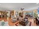 Open-concept living room featuring modern decor, hardwood floors, and a dining area at 8140 Terrace Garden N Dr # 103, St Petersburg, FL 33709