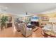Bright and spacious living room featuring hardwood floors, comfortable seating, and a ceiling fan at 8140 Terrace Garden N Dr # 103, St Petersburg, FL 33709