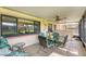 Relaxing screened porch with comfortable seating, a ceiling fan, and views of the outdoors at 8140 Terrace Garden N Dr # 103, St Petersburg, FL 33709