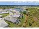 A picturesque aerial view of a lakefront community featuring homes with private pools and manicured lawns at 8364 Sea Glass Ct, Sarasota, FL 34240