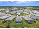 A beautiful aerial shot capturing a neighborhood surrounding a tranquil lake with well-maintained lawns and pools at 8364 Sea Glass Ct, Sarasota, FL 34240