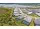 An eye-level shot of a neighborhood with scenic ponds, houses featuring covered pools, and manicured lawns at 8364 Sea Glass Ct, Sarasota, FL 34240