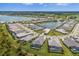 A high-angle aerial photograph revealing a community with water views, private pools, and meticulous landscaping at 8364 Sea Glass Ct, Sarasota, FL 34240
