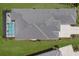 An overhead view of the home displaying its tile roof, screened-in pool, manicured lawn, and landscape details at 8364 Sea Glass Ct, Sarasota, FL 34240
