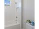Bright bathroom featuring a bathtub with a shower head, and a plant beside the toilet at 8364 Sea Glass Ct, Sarasota, FL 34240
