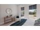 Bright bedroom featuring a cozy chair, modern decor and an inviting bed with a decorative throw and a side view at 8364 Sea Glass Ct, Sarasota, FL 34240