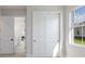 Bright bedroom featuring white doors, sliding closet, and window with natural light at 8364 Sea Glass Ct, Sarasota, FL 34240