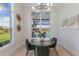 Bright dining area with a view of the outdoor pool and lush landscaping through large windows at 8364 Sea Glass Ct, Sarasota, FL 34240