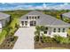 A well-manicured lawn, paver driveway, and landscaped front yard enhance the curb appeal of this modern home at 8364 Sea Glass Ct, Sarasota, FL 34240