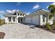 Charming two-story home with a three-car garage and a large brick paver driveway at 8364 Sea Glass Ct, Sarasota, FL 34240